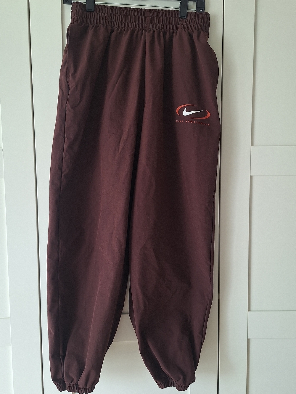 Trendy Nike Brown Elastic Waist Track Pants with White Swoosh Tag, Baggy Style
